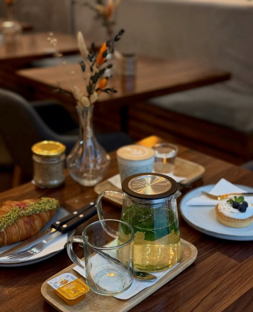 Just Croissant — table with tea, croissant and pastry